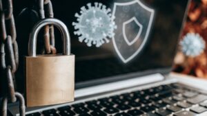 A close-up of a laptop with a padlock and digital antivirus icons representing cybersecurity and free antivirus protection in 2025
